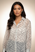 Close-up studio photoshoot highlighting horseshoe print shirt